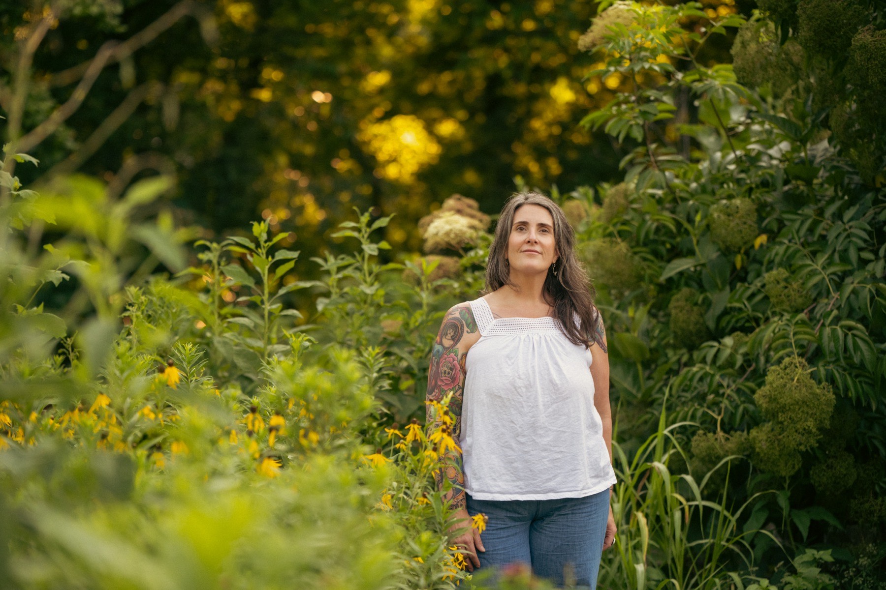 Angelyn Nicholson outdoors among late-summer wildflowers